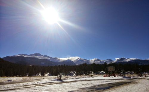 Scenic view of snowcapped mountains against blue sky