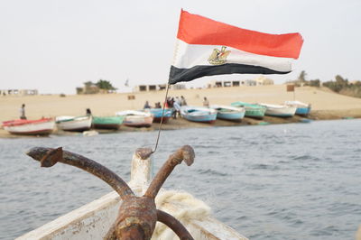 Close-up of egyptian flag on boat in sea against clear sky