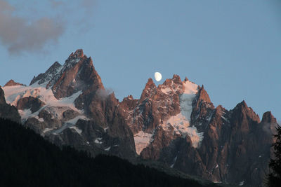 Low angle view of rocky mountains against sky