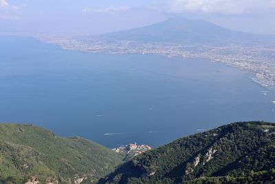 High angle view of sea and mountains against sky