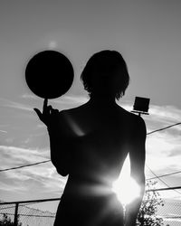 Low angle view of silhouette man standing against sky during sunset