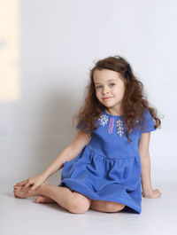 Portrait of smiling girl sitting on floor