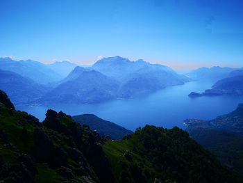 Scenic view of mountains against blue sky