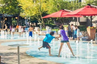 Children playing at fountains