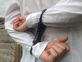Midsection of man wearing handcuffs