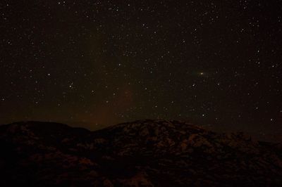 Scenic view of mountain against star field at night