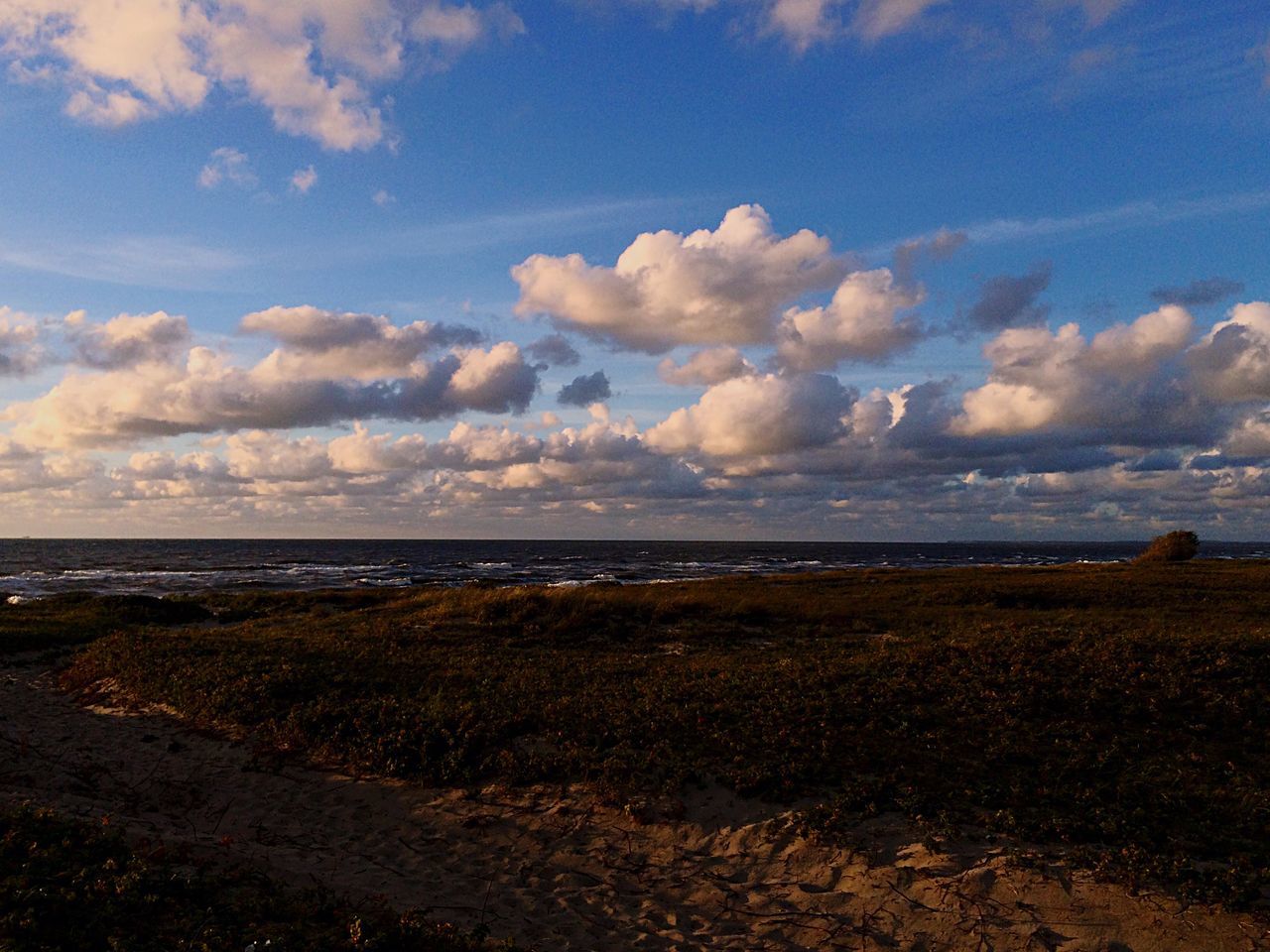 sea, tranquil scene, water, beach, horizon over water, tranquility, sky, scenics, shore, blue, cloud, beauty in nature, coastline, nature, calm, cloud - sky, non-urban scene, remote, day, majestic, outdoors, solitude, seascape, ocean, no people, cloudy, vacations, cloudscape