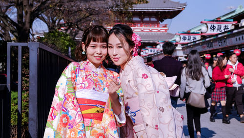 Portrait of a smiling young couple standing  with traditional japanese cloth called kimono 