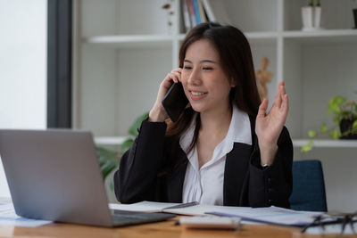 Businesswoman using laptop at office