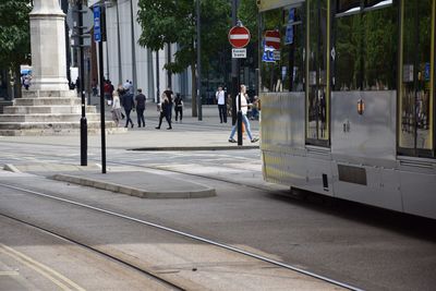 People walking on road in city