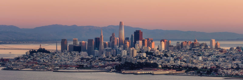 Panoramic view of city of san francisco by sea against sky