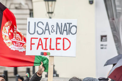 Low section of woman holding flag