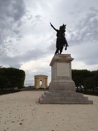 Low angle view of statue against cloudy sky