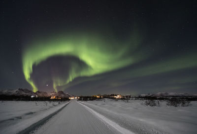 Scenic view of snowy landscape against sky at night