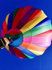 Low angle view of colorful hot air balloon against clear blue sky