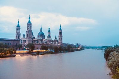 River amidst buildings against sky in city