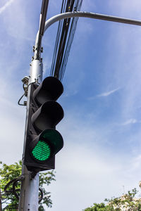 Low angle view of road signal against sky