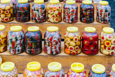 Close-up of multi colored food in jars for sale in market