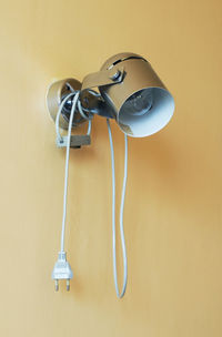 Close-up of electric lamp against wall