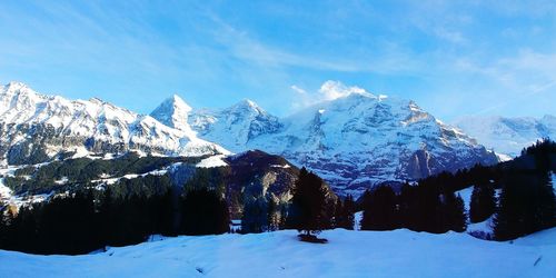 Scenic view of snowcapped mountain against blue sky