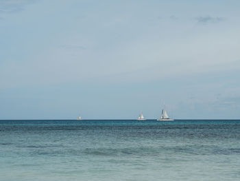 Sailboat sailing on sea against sky