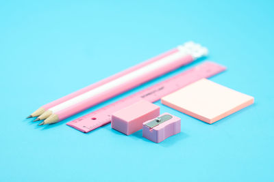 Close-up of school supplies against blue background