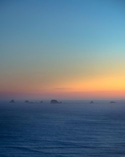 Scenic view of sea against clear sky during sunset