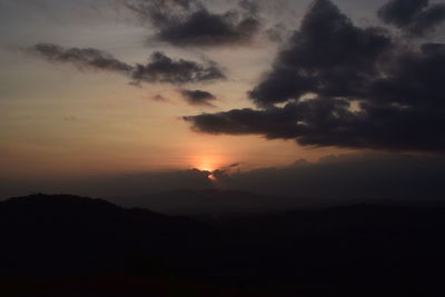 Scenic view of silhouette mountain against dramatic sky