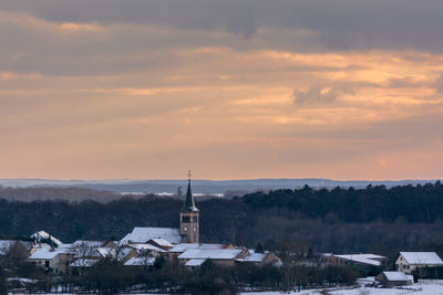 View of tower against cloudy sky during winter