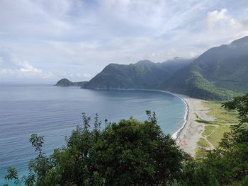 High angle view of sea and mountains against sky