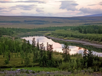 Scenic view of landscape and lake against sky