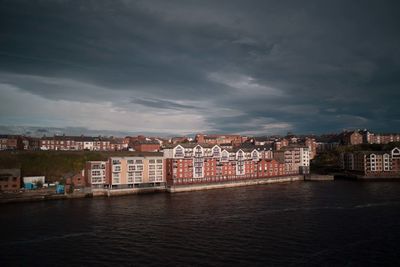 Town by sea against sky in city