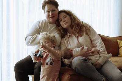 Portrait of family with grandmother and daughter holding a newborn son