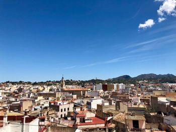 High angle view of townscape against blue sky