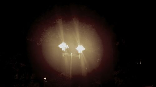 Low angle view of illuminated street light at night