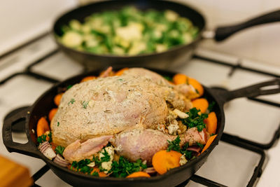 High angle view of meat and vegetables in frying pan