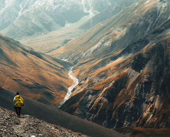 Rear view of man walking on mountain