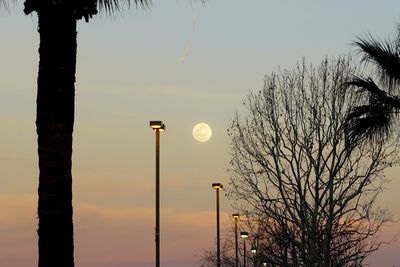 Silhouette of street light against sky at dusk