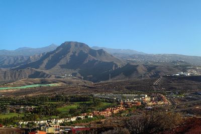 Scenic view of mountains against clear blue sky