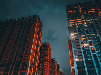 Low angle view of skyscrapers lit up at night