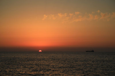 Scenic view of sea against romantic sky at sunset