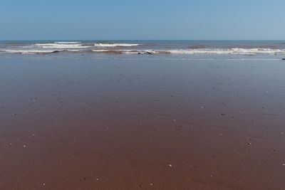 Scenic view of beach against clear sky