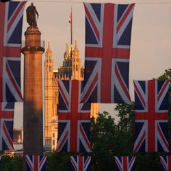 Low angle view of british flag against palace of westminster