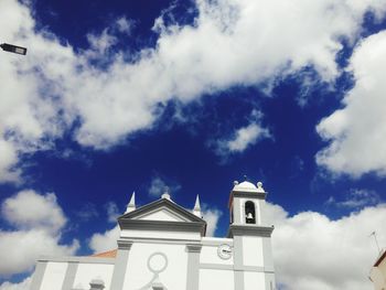 Low angle view of bell tower against sky