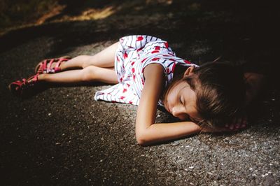 High angle view of woman lying on land