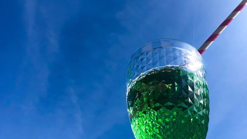 Low angle view of glass of blue sky