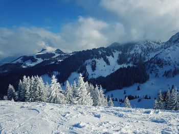 Scenic view of snowcapped mountains against sky