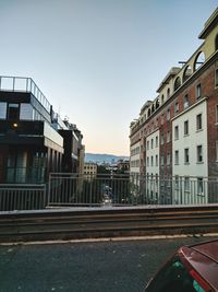 City street by buildings against sky