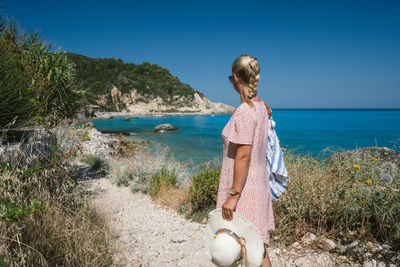 Woman on beach against sky
