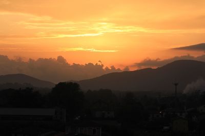 Scenic view of silhouette mountains against sky during sunset